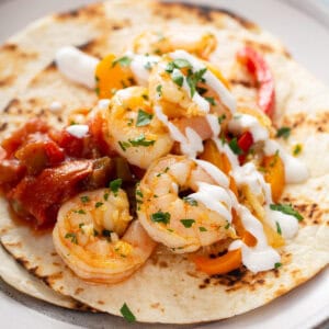 sauteed shrimp on flour tortilla with sour cream and salsa