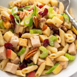 portion of turkey apple pasta salad in white bowl