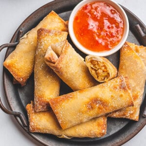 overhead shrimp egg rolls on serving platter with sweet chili sauce