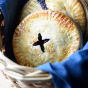 Blueberry hand pies in basket with blue cloth napkin