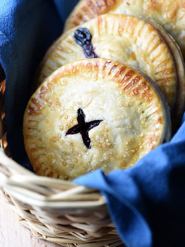 Blueberry hand pies in basket with blue cloth napkin