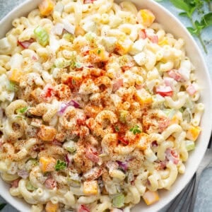 Aerial view of a big bowl of macaroni salad with egg, topped with paprika
