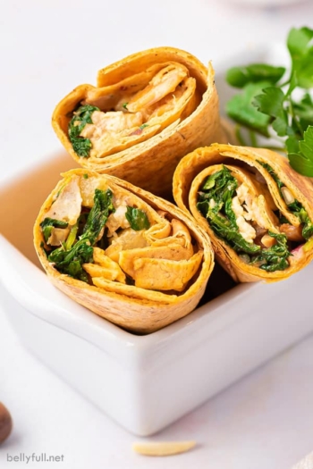 3 half chicken wraps in white basket