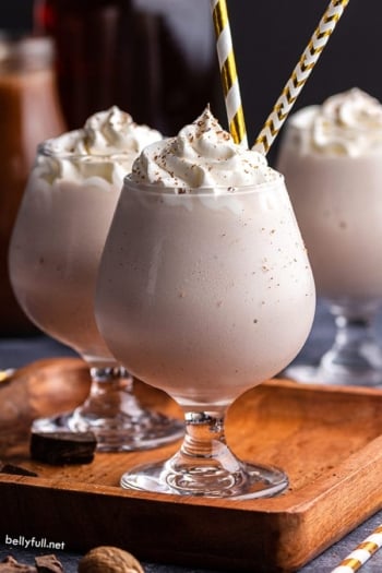 Brandy Alexander Milkshake in dessert glass with gold striped straws