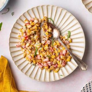 overhead image of corn salad on ornate plate with spoon