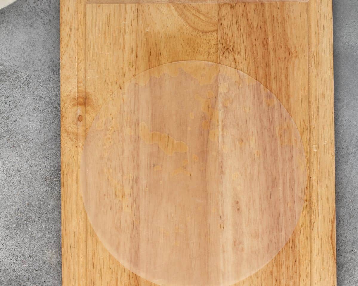 Wet rice paper on a wooden cutting board.
