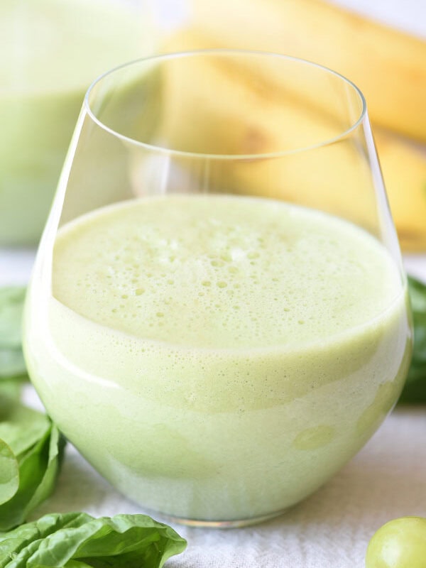 glass filled halfway with green smoothie