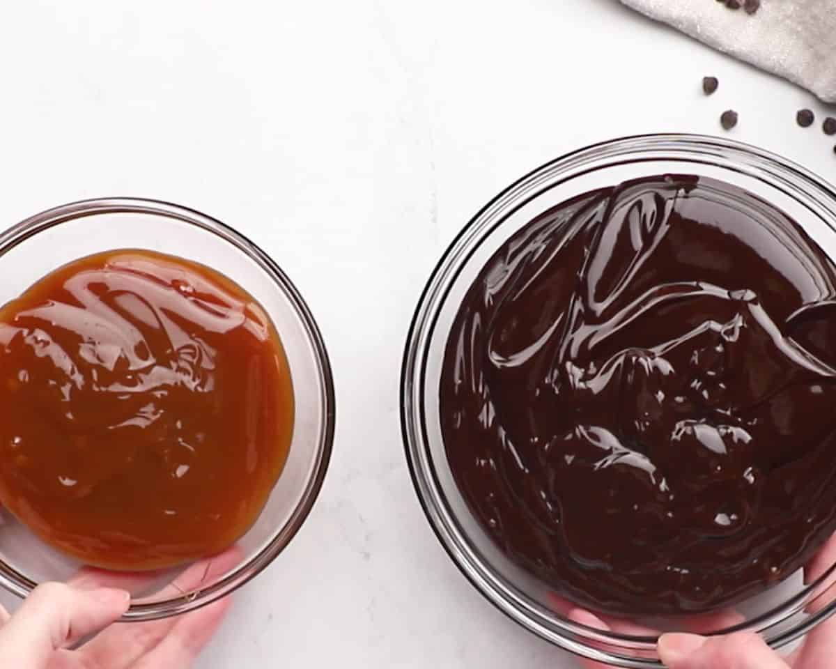 Caramel sauce and chocolate sauce in glass bowls.
