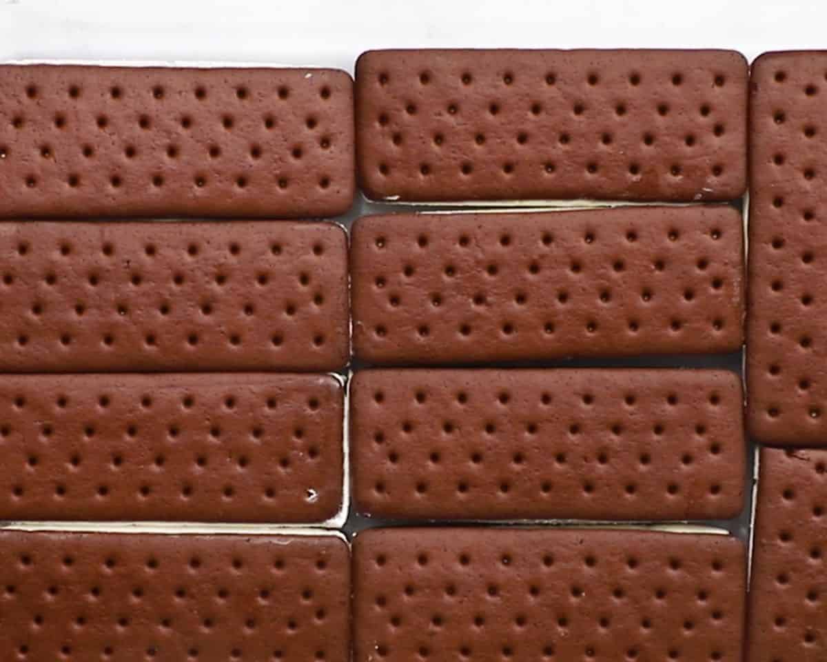 Ice cream sandwiches lying in the bottom of a casserole dish.