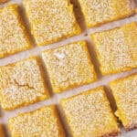 overhead close up cut lemon bar squares on parchment paper