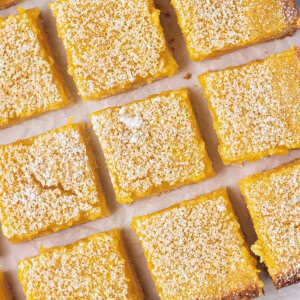 overhead close up cut lemon bar squares on parchment paper