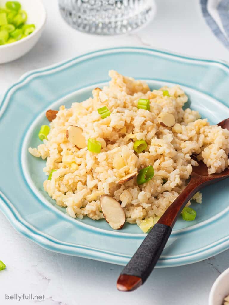 rice with pineapple on blue plate with spoon