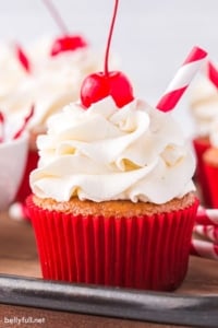 root beer float cupcakes with vanilla frosting and a Maraschino cherry on top