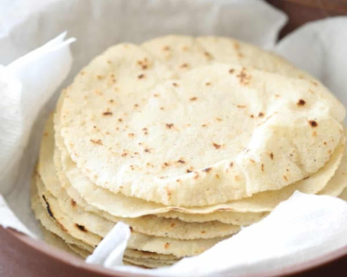 Homemade corn tortillas in a bowl.