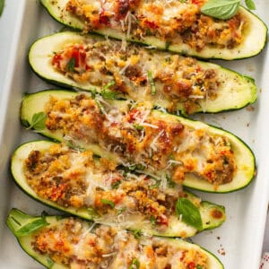 overhead stuffed zucchini boats in white casserole dish