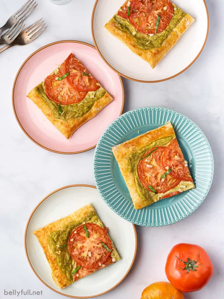 4 colored plates with a slice of baked puff pastry tart