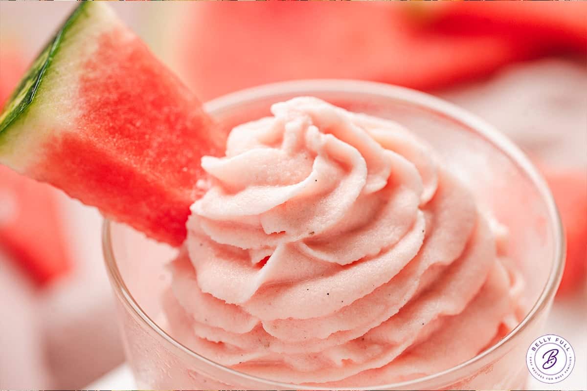 This Watermelon Dole Whip is a luscious, creamy no-bake treat that's so easy to make! It's a light, fruity dessert perfect for summer. Close up of watermelon Dole whip