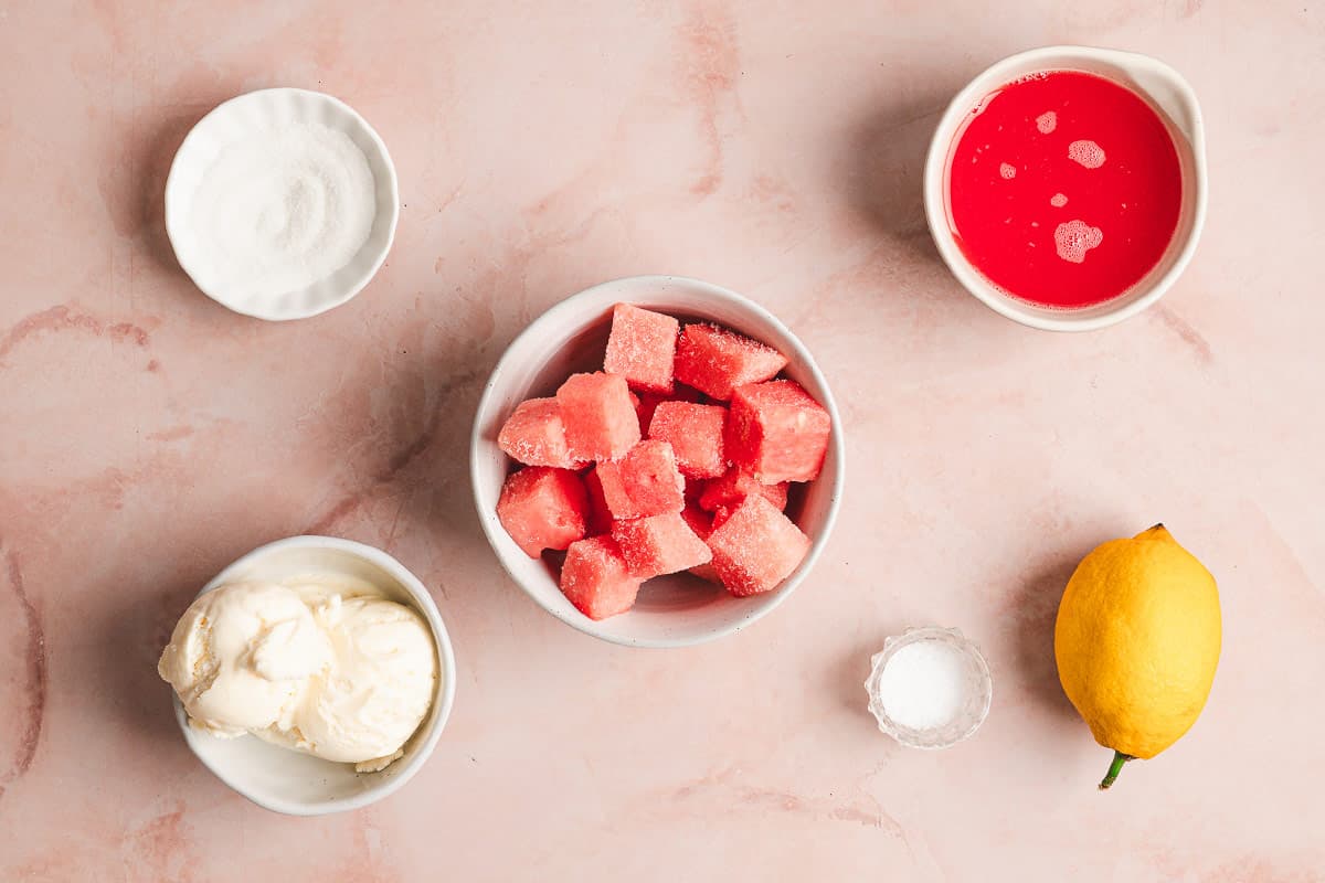 This Watermelon Dole Whip is a luscious, creamy no-bake treat that's so easy to make! It's a light, fruity dessert perfect for summer. Overhead view of ingredients needed to make watermelon Dole whip