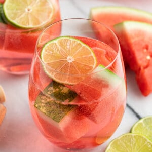 glass filled with watermelon sangria and lime slice