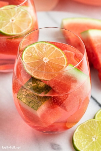 glass filled with watermelon sangria and lime slice