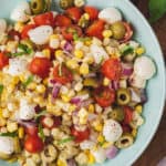 close up overhead caprese corn salad in serving bowl