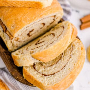 A fresh loaf of cinnamon swirl bread with two slices sliced