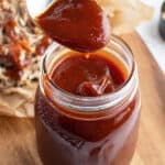 spoonful of BBQ sauce over glass jar