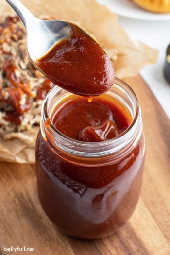 spoonful of BBQ sauce over glass jar