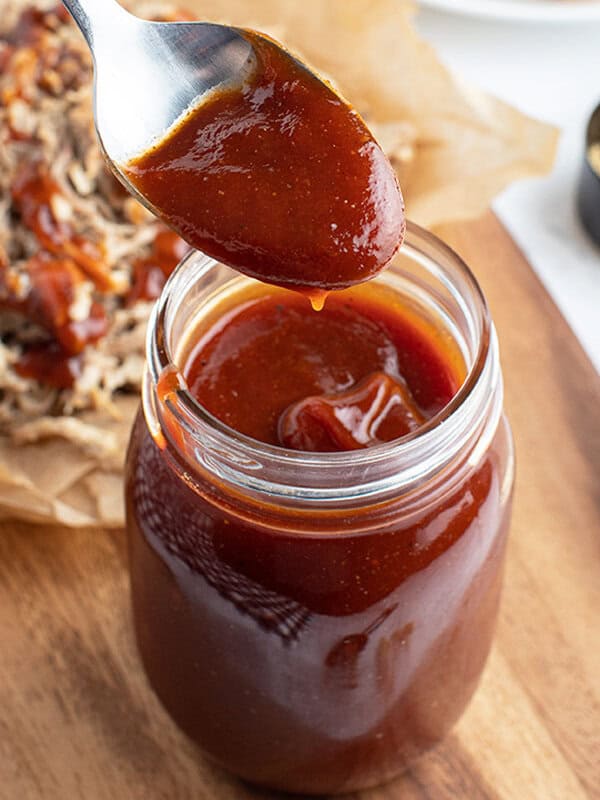 spoonful of BBQ sauce over glass jar