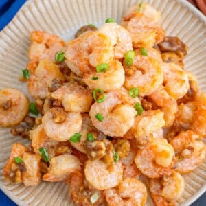 A plate of honey walnut shrimp topped with scallions