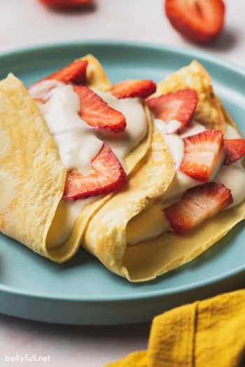 strawberry crepes with cream filling and fresh sliced strawberries