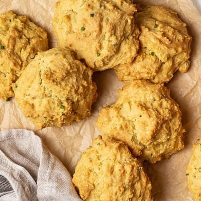 5 golden biscuits piled on brown parchment paper