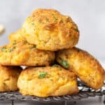 pile of cheddar bay biscuits on cooling rack