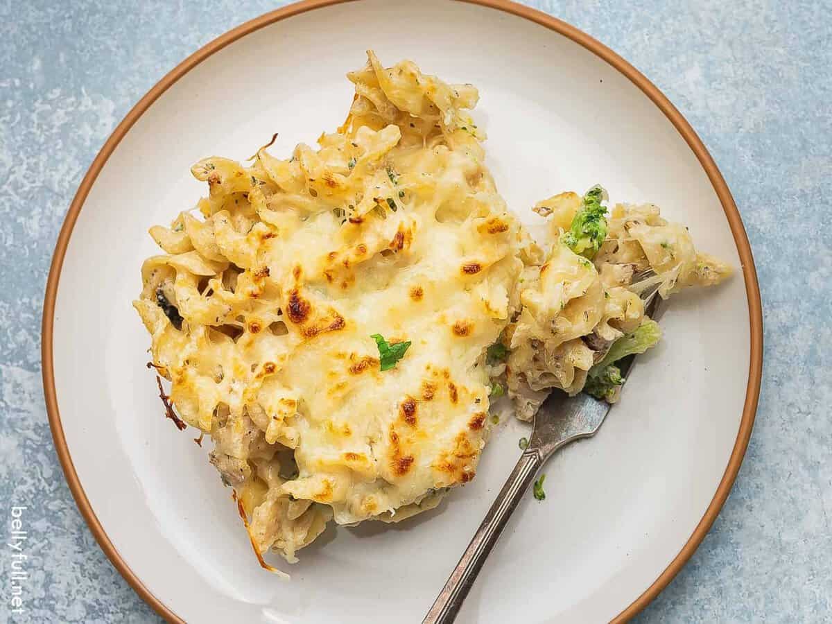 A serving of chicken Alfredo bake on a white plate.