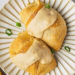 Two chicken crescent roll ups topped with gravy