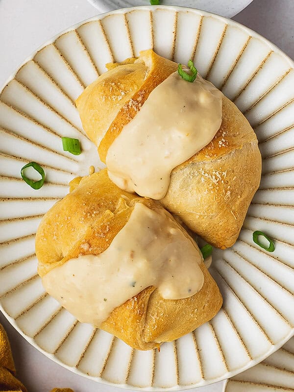 Two chicken crescent roll ups topped with gravy