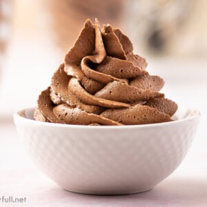 chocolate buttercream frosting piped in a white bowl