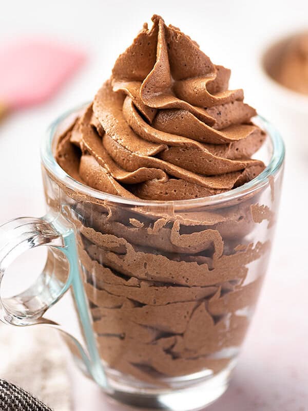 chocolate frosting piped tall in a clear glass