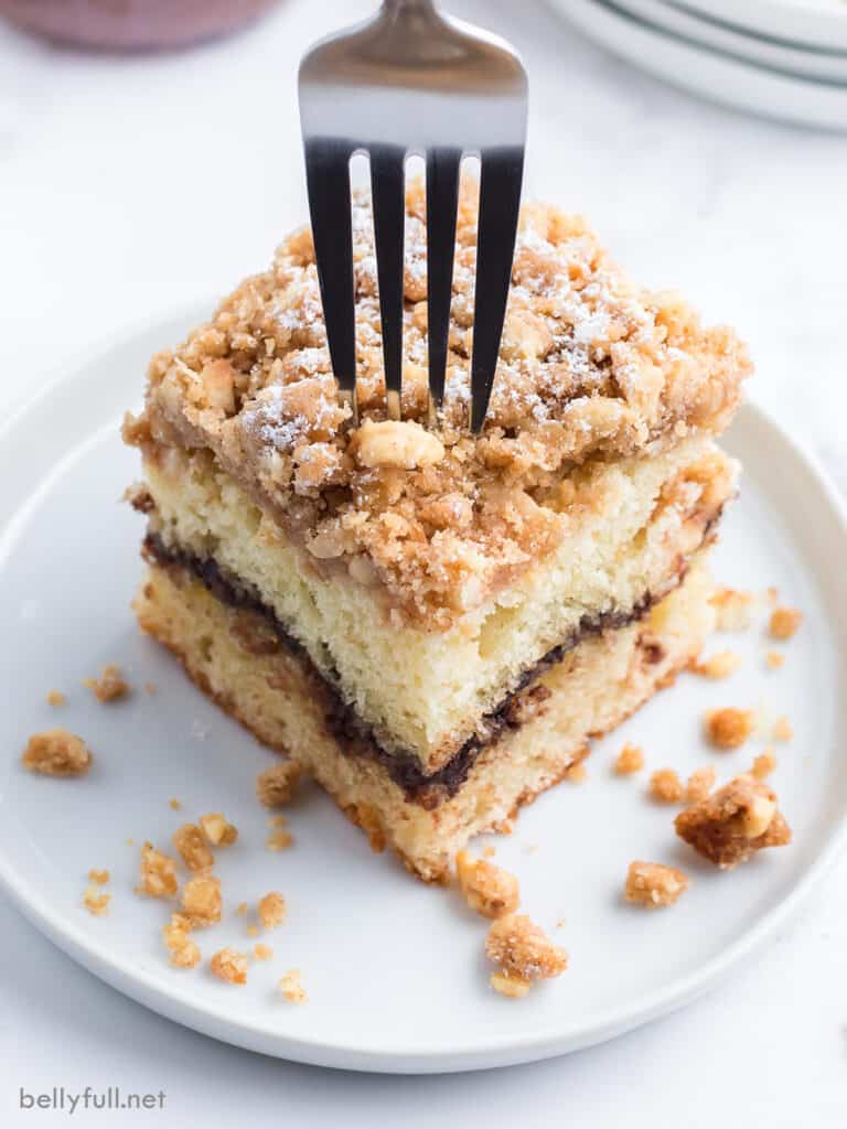 fork inserted into a slice of coffee cake