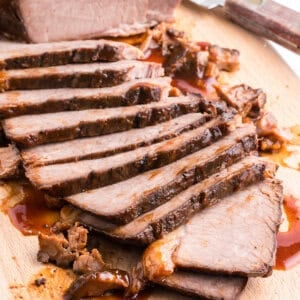 slow cooker beef brisket sliced thin on cutting board