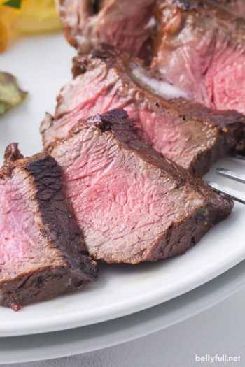 close up sliced steak in easy steak marinade on a plate