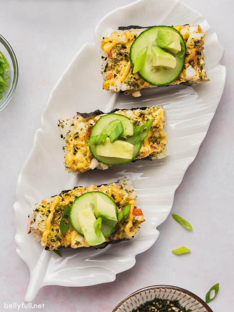 overhead of 3 sushi portions on a leaf shaped plate