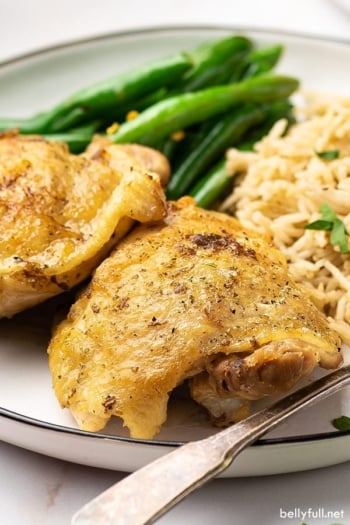 Crispy apple cider chicken on a plate, with a form in front