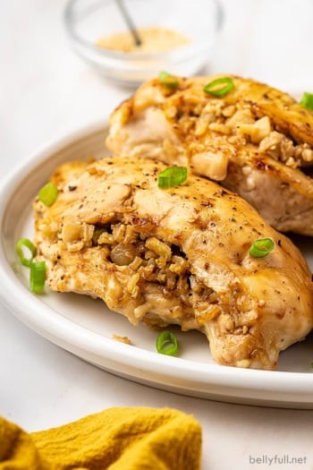 Two rice stuffed chicken breasts on a plate