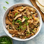 Moo shu pork stir fry in white serving bowl