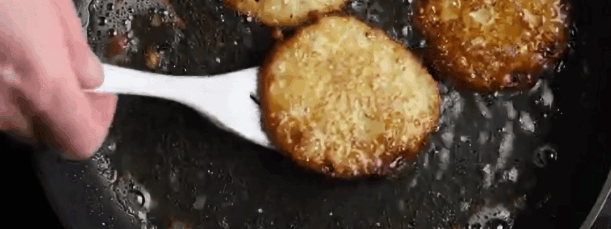 Frying potato latkes.