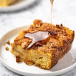 square piece of french toast casserole with syrup being poured on top