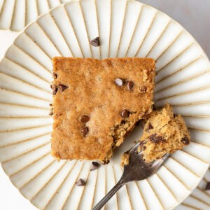 square piece of cake with mini chocolate chips on plate with fork