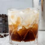 A slightly swirled white russian cocktail