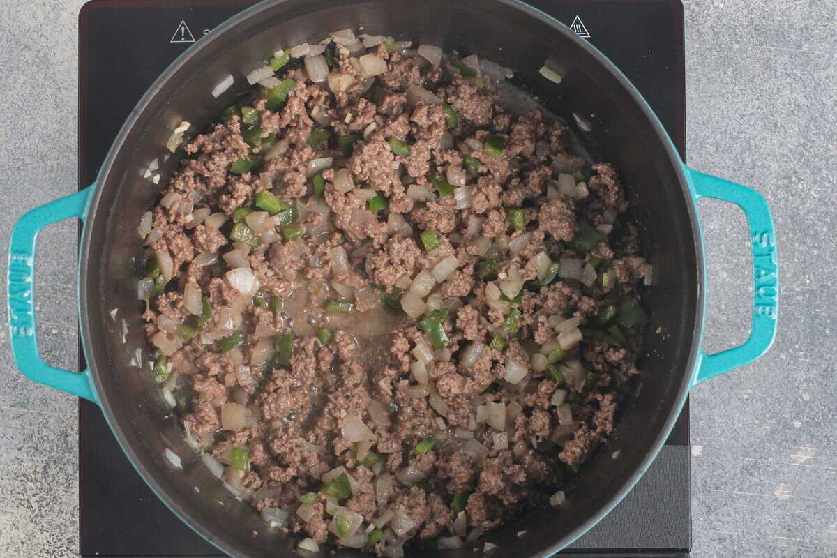 Ground beef added to the pot with the onion and poblano.